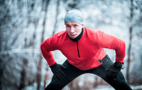 runner stretching in cold weather