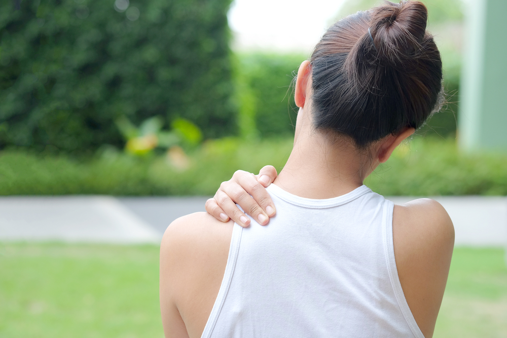 Women have neck pain, shoulder pain, at the park health concept