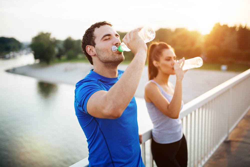 couple drinking water during exercise