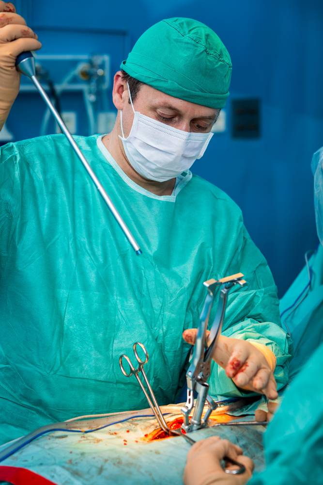 Surgeon preforming open spine surgery