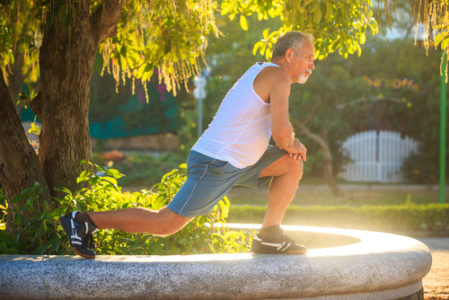 man stretching knee