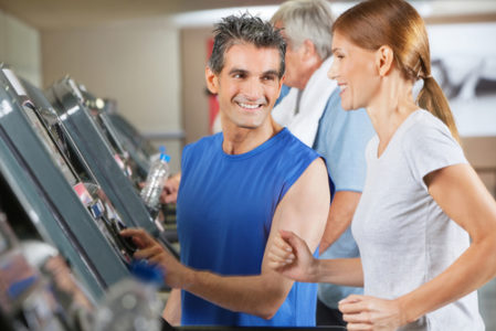 physical trainer coaching runner on treadmill