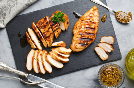 sliced grilled chicken on a platter