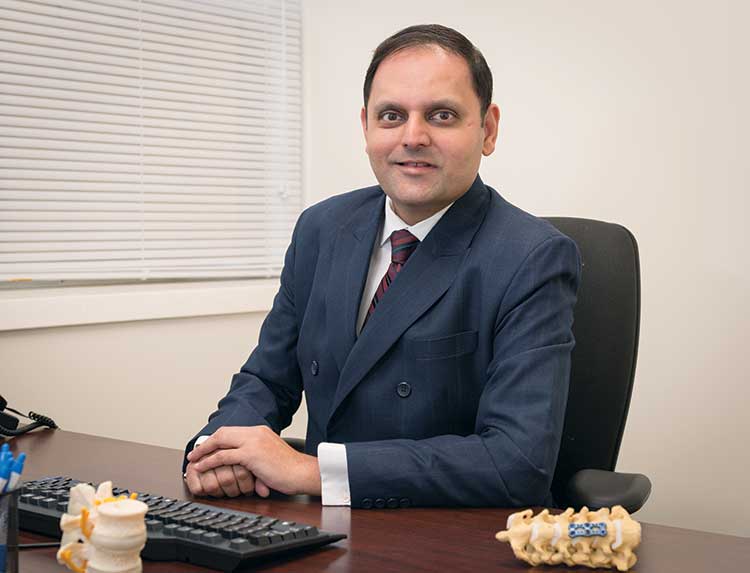 dr shah sitting at desk